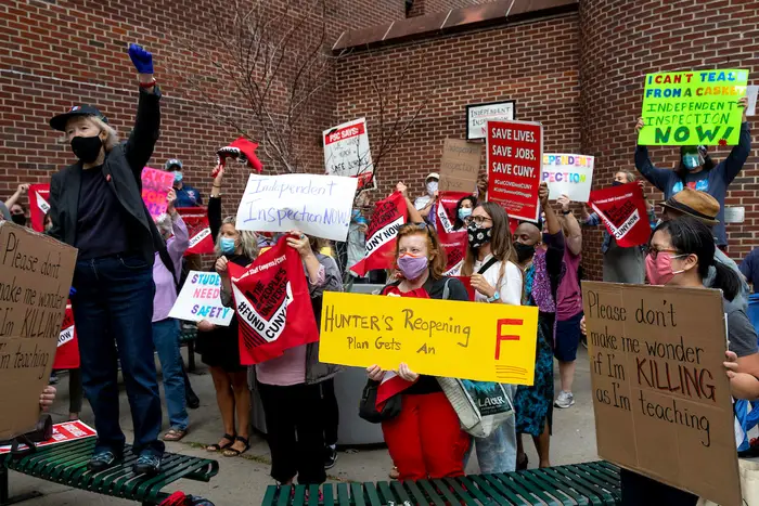 Teachers protest, holding up signs that read, "Hunter's Opening Gets An F" and "Save Lives. Save Jobs. Save CUNY," outside Hunter College High School recently.